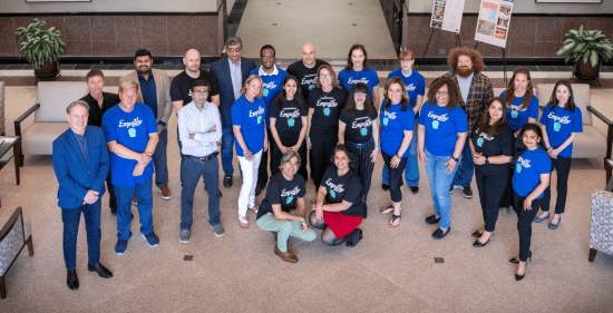A diverse group of professionals posing in a corporate setting